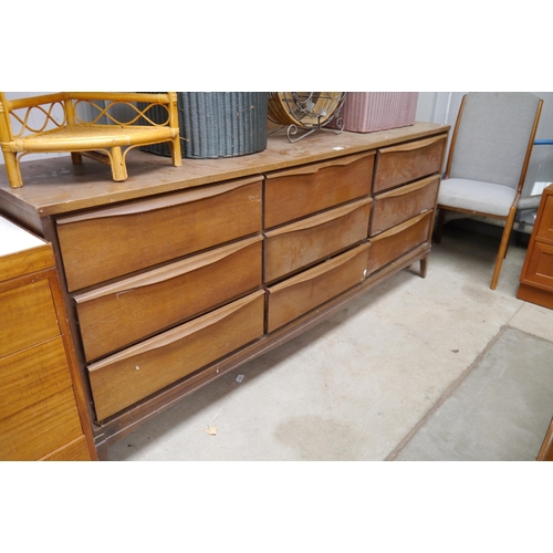 2428 - A 1970's teak sideboard chest of 9 drawers, back lose, barn stored