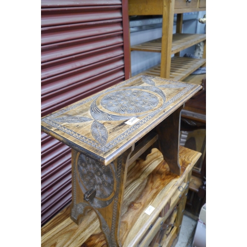 2449 - An Arts and Crafts heavily carved side table