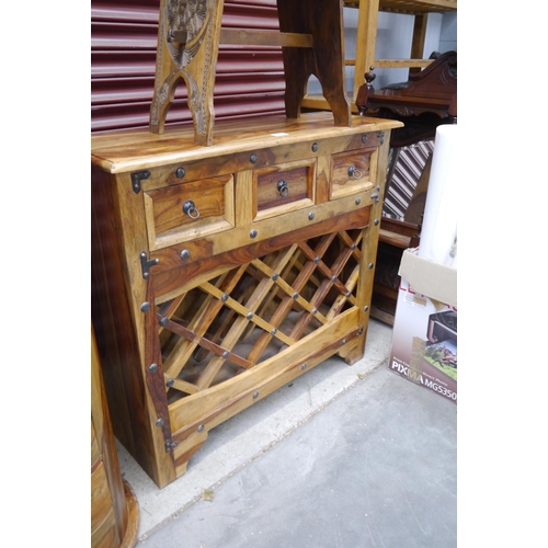 2450 - A mango wood bottle rack sideboard