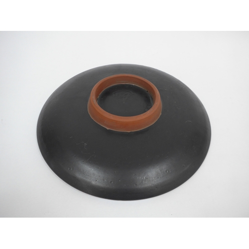 7022 - A mid 20th Century thrown pottery pedestal dish, black glazed with stylised coloured glaze design. I... 