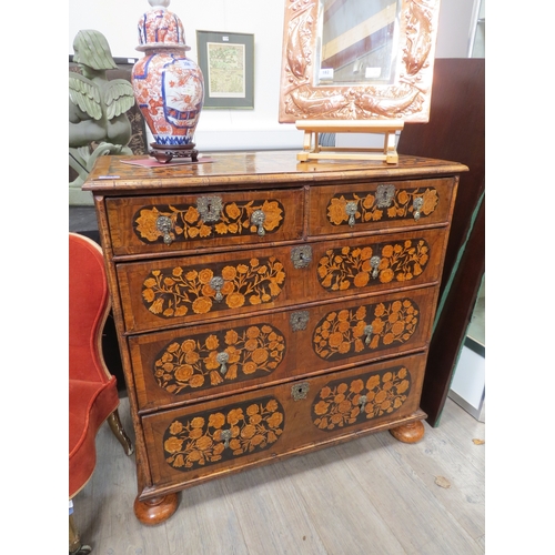 6001 - An 18th Century chest of two short over three graduated long drawers, floral inlay, bun feet with ke... 