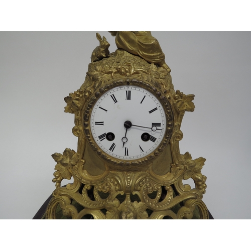 6027 - A late 19th century French ormolu mantel clock surmounted by child and rabbit with grape and vine st... 