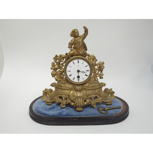 6036 - A late 19th century French gilt clock surmounted by a figure with grape bush detail. White enamel ro... 