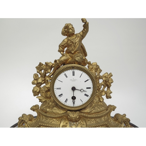 6036 - A late 19th century French gilt clock surmounted by a figure with grape bush detail. White enamel ro... 