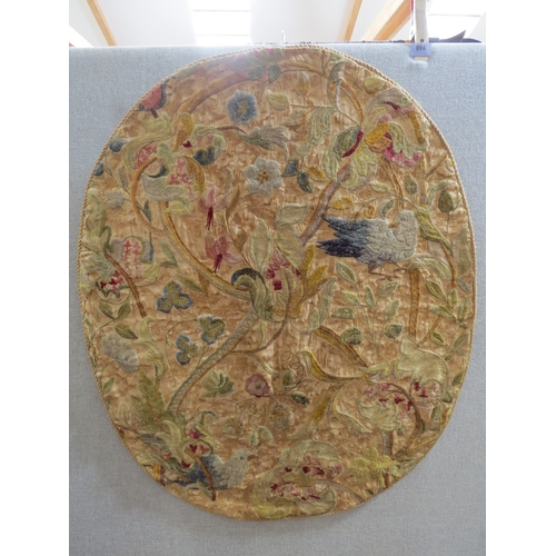 6053 - A Georgian oval stump work panel, birds foliage multiple areas of damage, 98cm x 80cm