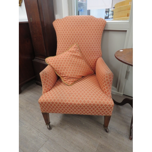 6061 - An Edwardian upholstered arm chair, with shaped back, raised up on a tapering square section front l... 