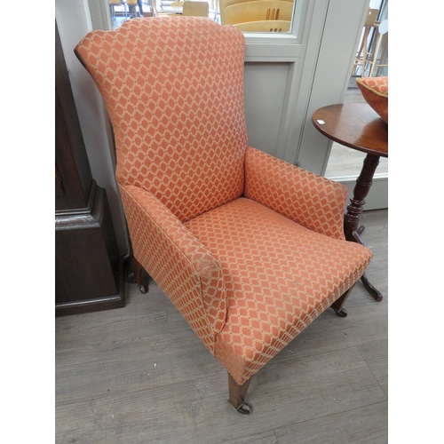 6061 - An Edwardian upholstered arm chair, with shaped back, raised up on a tapering square section front l... 