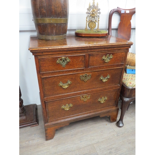 6046 - An early George III oak straight front chest of two short over two long graduated drawers, of small ... 