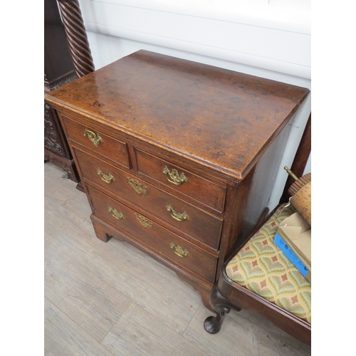 6046 - An early George III oak straight front chest of two short over two long graduated drawers, of small ... 