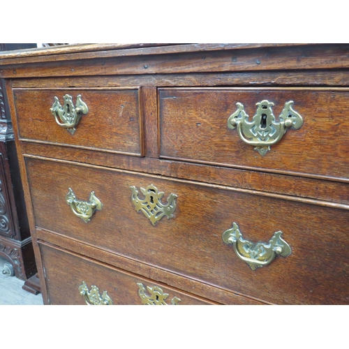 6046 - An early George III oak straight front chest of two short over two long graduated drawers, of small ... 