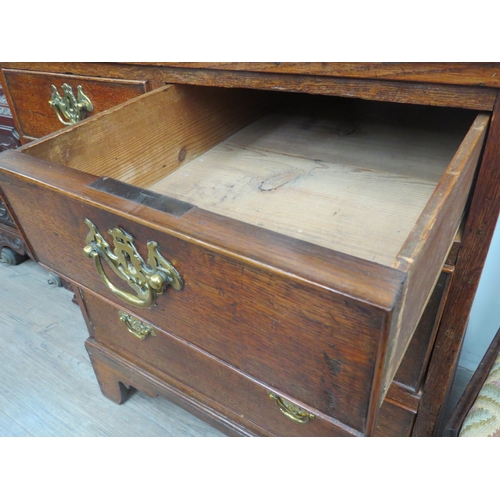 6046 - An early George III oak straight front chest of two short over two long graduated drawers, of small ... 