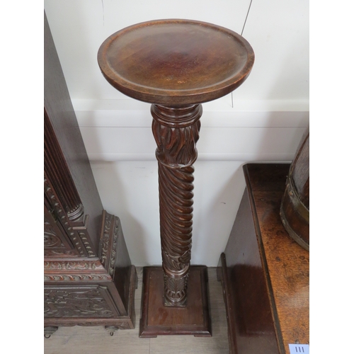 6047 - A 19th Century carved mahogany column torchere, with acanthus-capped wrythen-fluted stem, on a squar... 