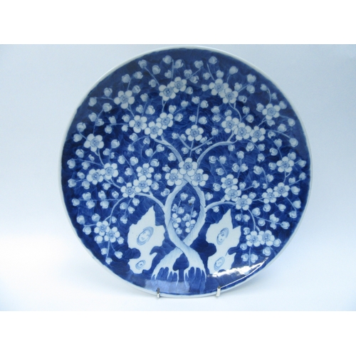 6011 - An Oriental blue and white prunus blossom charger, 32cm diameter