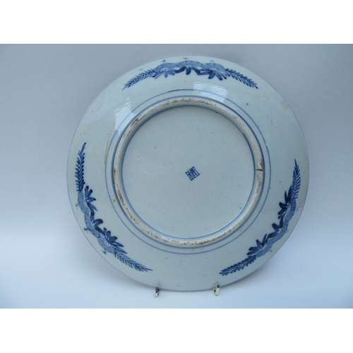 6011 - An Oriental blue and white prunus blossom charger, 32cm diameter