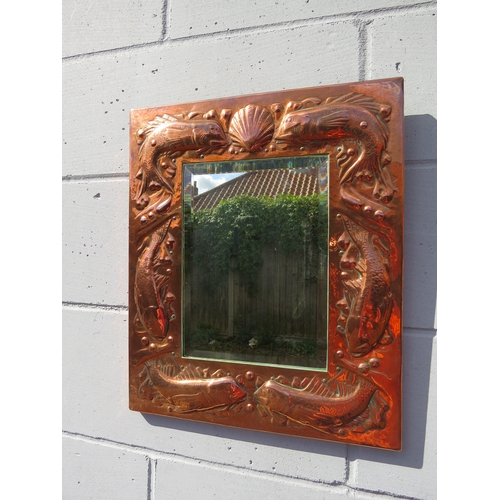 6002 - A Newlyn Arts & Crafts embossed copper mirror frame with fish and shell detail bevelled glass impres... 