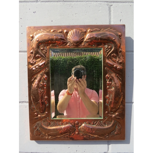 6002 - A Newlyn Arts & Crafts embossed copper mirror frame with fish and shell detail bevelled glass impres... 