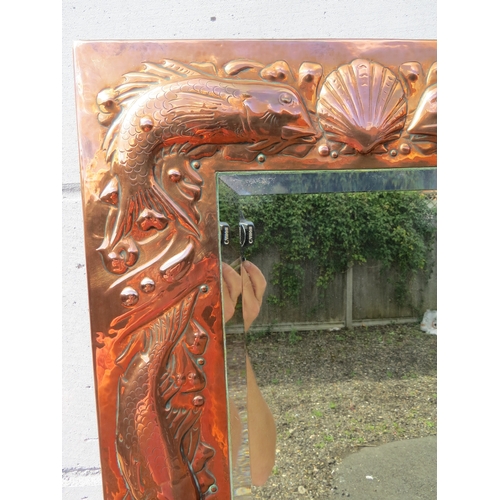 6002 - A Newlyn Arts & Crafts embossed copper mirror frame with fish and shell detail bevelled glass impres... 