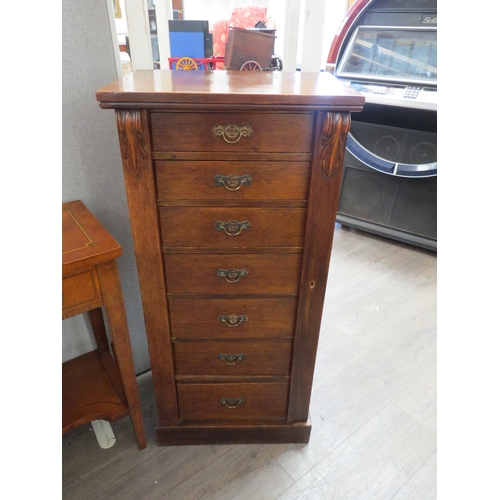 6058 - An Edwards oak Wellington chest of seven drawers, 184cm x 49cm x 34cm