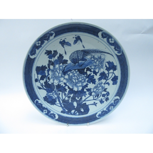 6012 - An 18th Century Chinese blue and white charger decorated with flowers and golden pheasant, four char... 