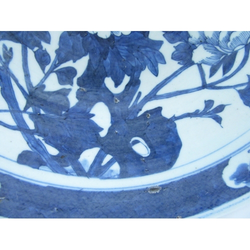 6012 - An 18th Century Chinese blue and white charger decorated with flowers and golden pheasant, four char... 