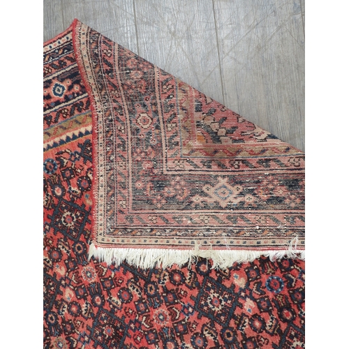 6465 - A handwoven Persian rug with central medallion, 317cm x 210cm