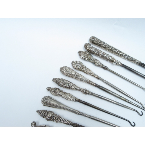 6387 - A good quantity of silver handled button hooks various sizes