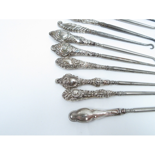 6387 - A good quantity of silver handled button hooks various sizes