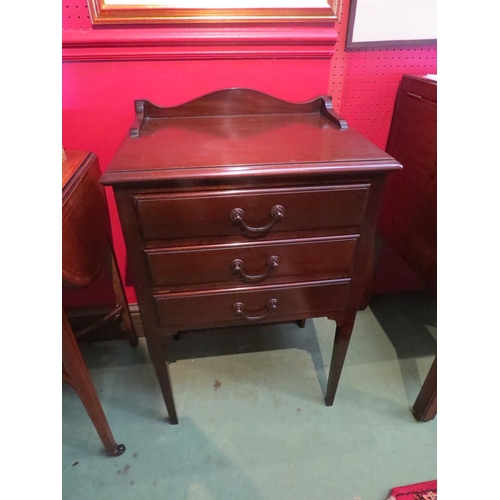 4117 - An Edwardian mahogany stationery chest of three drawers with drop-down fronts, the raised back over ... 