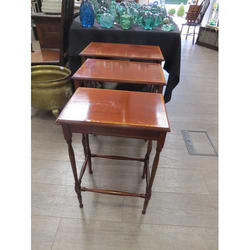 4282 - An Edwardian crossbanded inlaid mahogany nest of the three graduating occasional tables on turned le... 