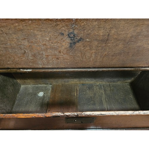 4285 - A 17th Century oak coffer of small proportions, the iron hinged lid over arch end supports, 40cm tal... 