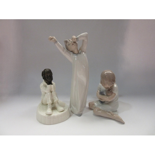 4315 - A Minton figurine of seated child 'Spellbound', 12 cm high, together with a Lladro figurine of yawni... 