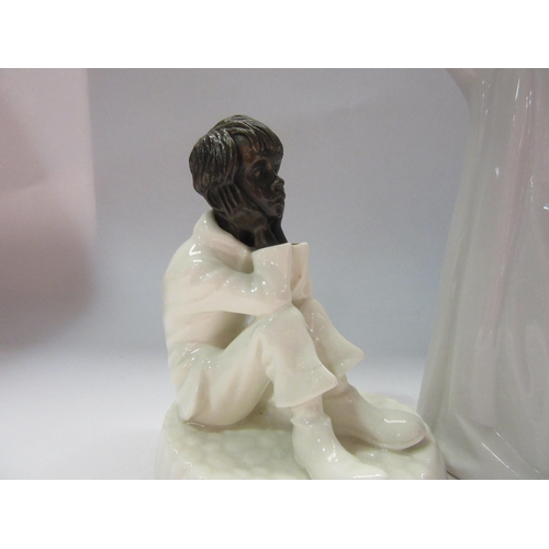 4315 - A Minton figurine of seated child 'Spellbound', 12 cm high, together with a Lladro figurine of yawni... 