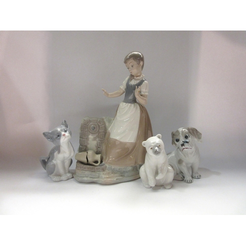 4333 - Four ceramic figures including a Lladro polar bear and cat, a Nao figure of a girl with broken vase ... 