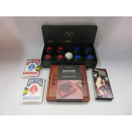 4375 - A group of tabletop games including cards, solitaire, mini carpet bowls and mini master mind