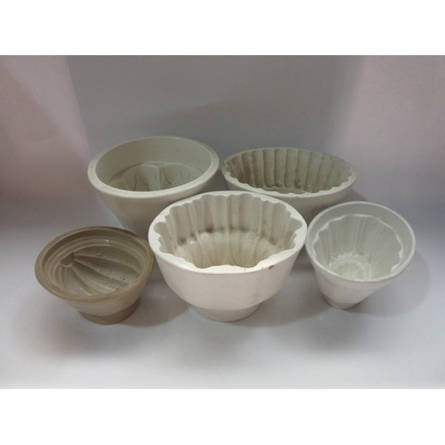 4379 - Five stoneware jelly moulds of varying sizes, smallest 8cm tall and largest 13cm, some are cracked