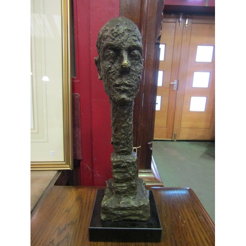 4011 - A sculptured abstract bronze head with elongated neck after Giacometti, 39cm tall