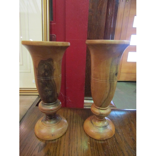 4012 - A pair of olive wood vases, 20cm tall