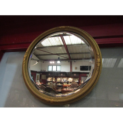 4021 - A gilt framed circular bevelled edge mirror, 43cm diameter