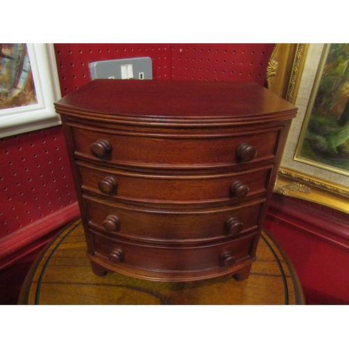 4054 - A Past Times mahogany jewellery box in the form of a chest of four graduated drawers, 23.5cm x 22.5c... 