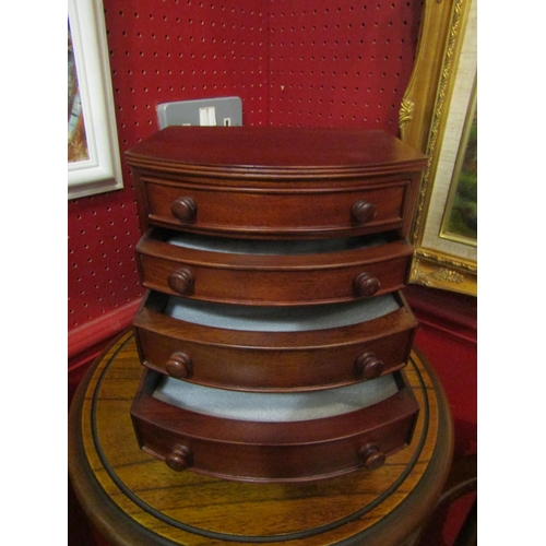 4054 - A Past Times mahogany jewellery box in the form of a chest of four graduated drawers, 23.5cm x 22.5c... 