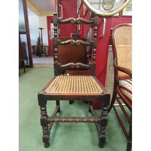 4125 - An oak scrolled triple rung ladder back chair with carved seat and block and bead legs tied by a bea... 