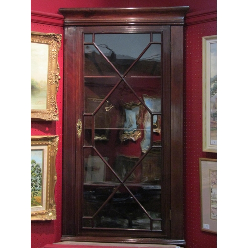 4067 - A Georgian mahogany wall-hanging corner display cupboard, with three straight shelves enclosed by an... 