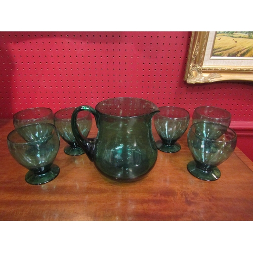 4085 - A green glass jug and a set of six glasses