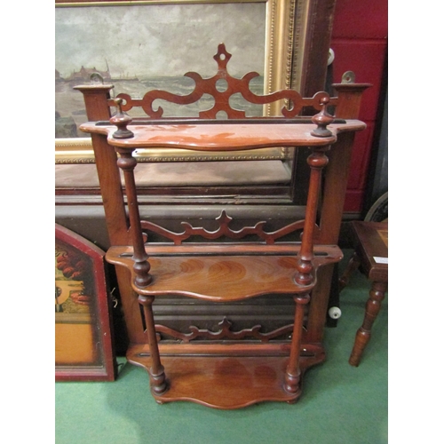 4246 - A set of Victorian walnut small three-tier wall shelves of serpentine form, with turned wood support... 