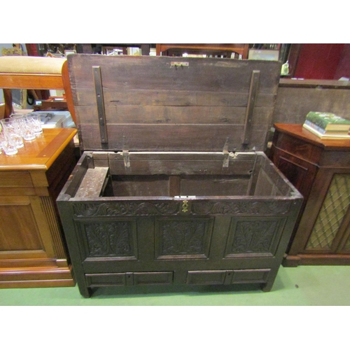 4259 - An early 18th Century oak triple panel mule chest, with leaf and flower carved frieze and facia over... 