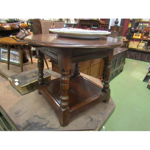 4264 - An 18th Century style country oak coffee table, circular top, turned supports over an under-tier, 48... 