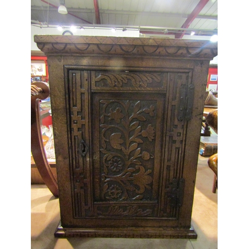 4274 - An 18th Century oak single door wall cupboard with carved door having iron 