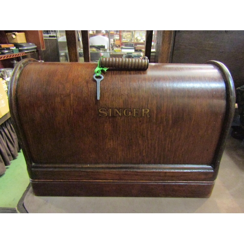 4290 - A Singer sewing machine, cased, and a sewing box with some contents