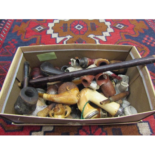 4304 - A quantity of tobacco related items to include various pipes and pipe ends, along with two associate... 