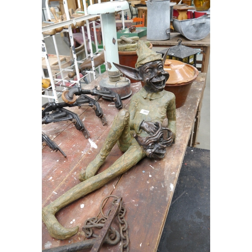 2010 - A solid bronze recumbent garden pixie figure with mask 3' long